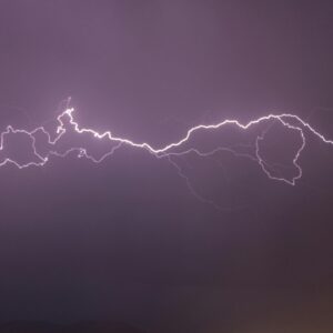 A vivid display of lightning bolts illuminating the night sky, capturing the electric power of a thunderstorm.